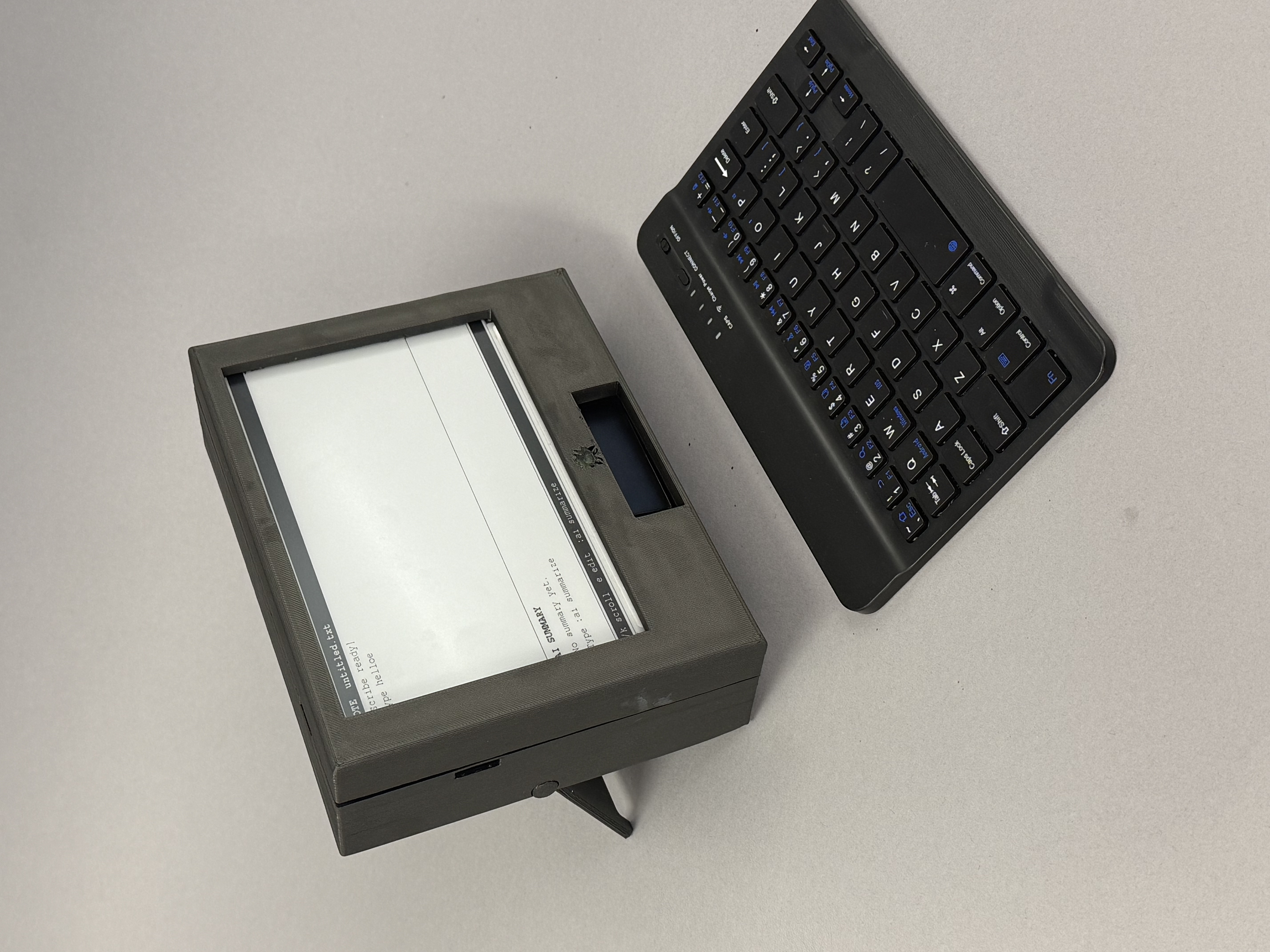 Assembled MonoScribe prototype in its 3D-printed enclosure with the E-Ink display and wireless keyboard